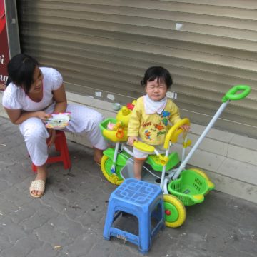 Une jeune maman cajole son enfant qui pleure car il ne vaut pas finir son repas